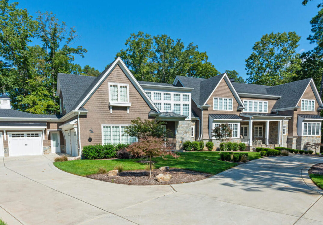 Large suburban house with brick exterior and well-kept landscaping.